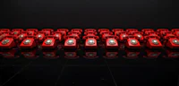 a row of red telephones on a black background