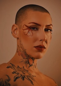 a woman with tattoos and a shaved head